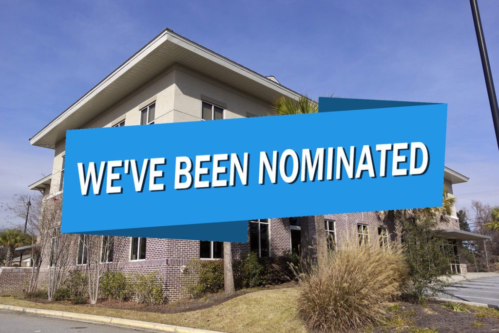 Burkett CPAs office with a blue banner over it that says "We've been nominated"