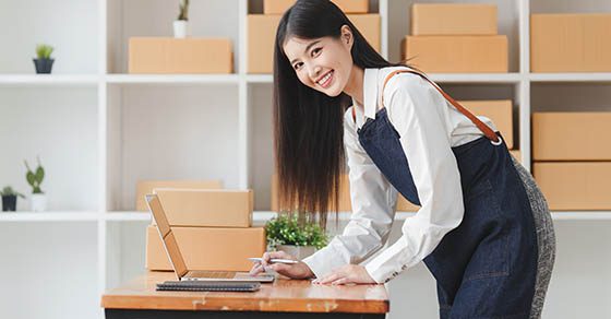Small businesses SME owners female entrepreneurs check online orders to prepare to pack the boxes, sell to customers