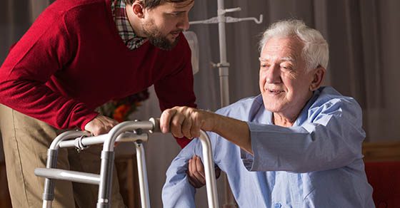 Photo of carer and person with walking disability